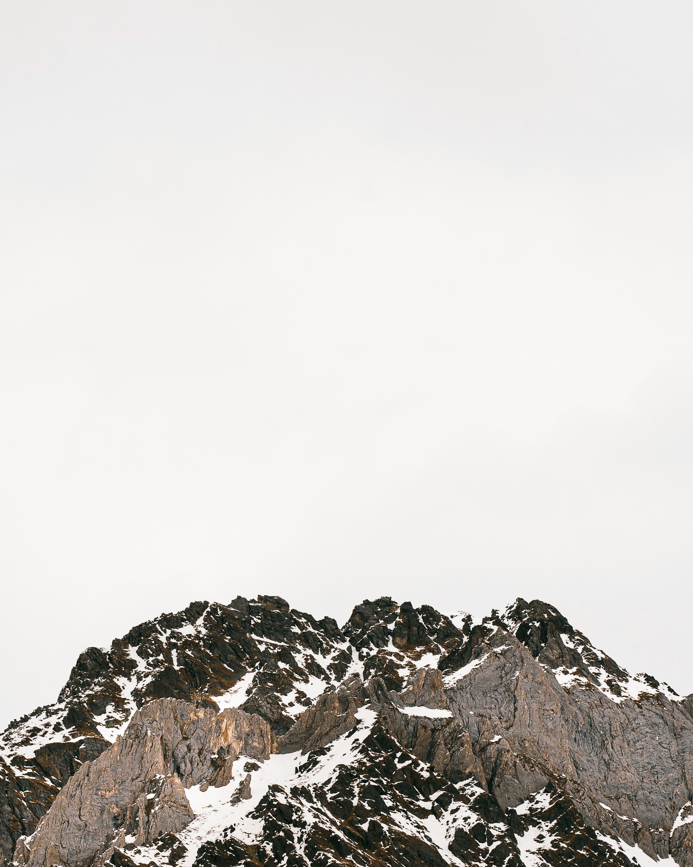 rocky mountain under white sky during daytime